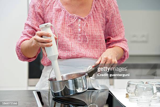 a woman mixing with a immersion blender - electric mixer stock pictures, royalty-free photos & images