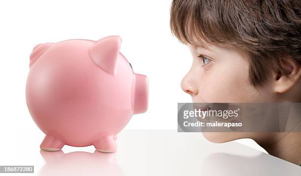 child with piggy bank - kids side view isolated stockfoto's en -beelden