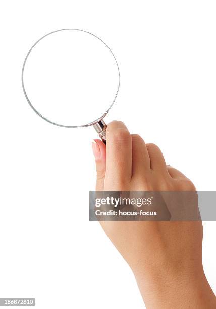 hand holding magnifying glass - vergrootglas stockfoto's en -beelden