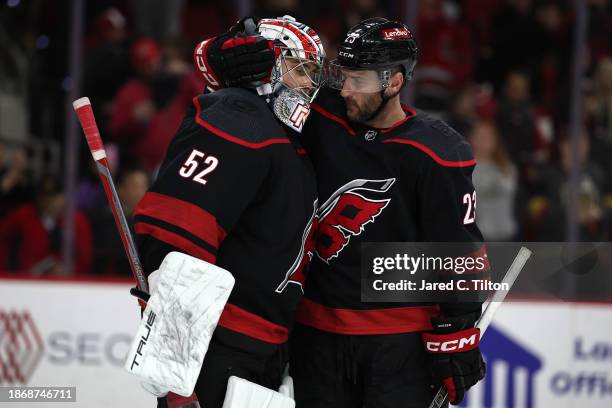 Pyotr Kochetkov and Stefan Noesen of the Carolina Hurricanes react following their 6-3 victory over the Vegas Golden Knights during the third period...