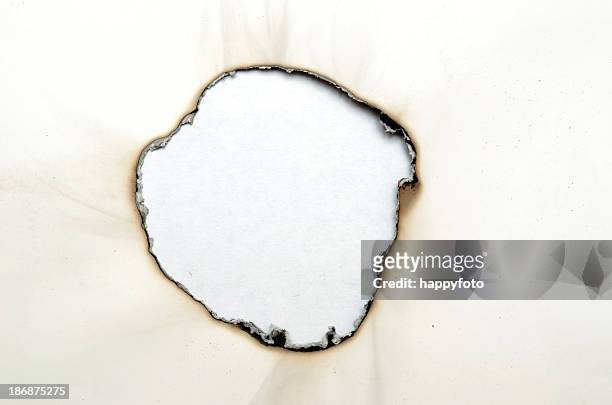 bruciato foro - burnt foto e immagini stock