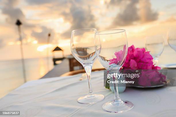 dinner table at beach sunset luxury holiday resort - tahiti flower stock pictures, royalty-free photos & images