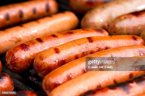 close up of grilled hotdogs on grill - hot dog bun stock pictures, royalty-free photos & images