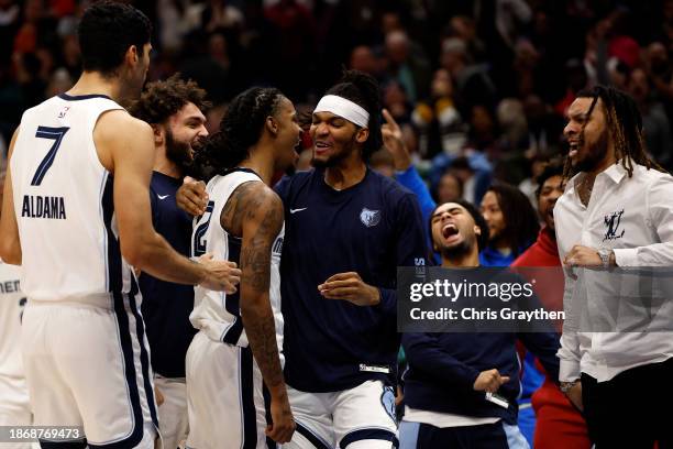 Ja Morant of the Memphis Grizzlies reacts with his team after defeating the New Orleans Pelicans at Smoothie King Center on December 19, 2023 in New...