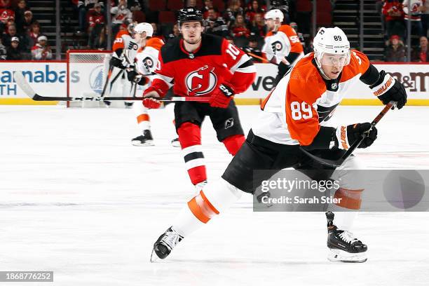 Cam Atkinson of the Philadelphia Flyers chases the puck during the first period against the New Jersey Devils at Prudential Center on December 19,...