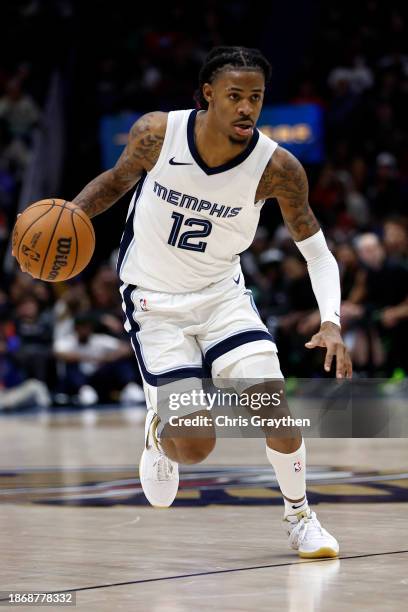 Ja Morant of the Memphis Grizzlies drives the ball up the court against the New Orleans Pelicans at Smoothie King Center on December 19, 2023 in New...