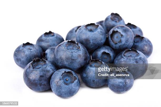 pile of fresh blueberries on white - blueberries fruit stock pictures, royalty-free photos & images