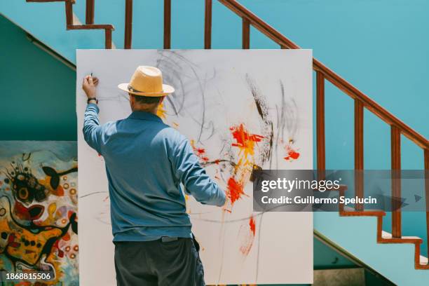 artist painting a canvas with charcoal - art passion stock pictures, royalty-free photos & images