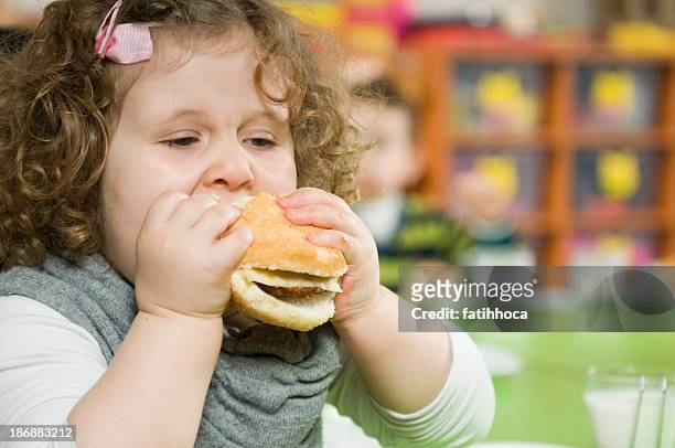 hamburger and the girl - kid eating burger bildbanksfoton och bilder