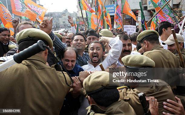 Bharatiya Janta Party workers scuffle with policemen during a protest against the price hike on the first day of the reopening of civil secretariat...