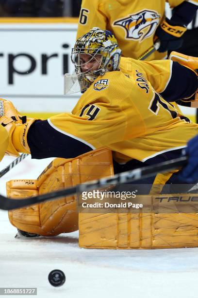 Juuse Saros of the Nashville Predators keeps his eye on the puck against the Vancouver Canucks at Bridgestone Arena on December 19, 2023 in...