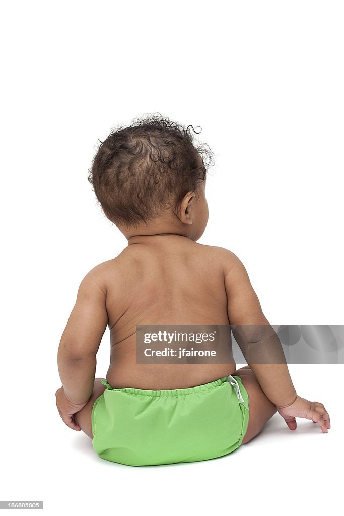 Baby in green cloth diaper from behind