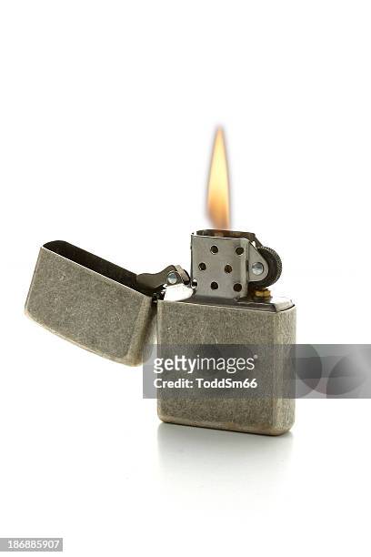 a lit cigarette lighter with the gray top folded open - cigarette lighter stock pictures, royalty-free photos & images