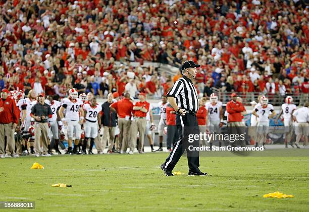 Referee is seen with penalty flags during the game between the Georgia Bulldogs and the Florida Gators at EverBank Field on November 2, 2013 in...