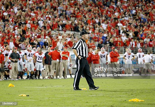 Referee is seen with penalty flags during the game between the Georgia Bulldogs and the Florida Gators at EverBank Field on November 2, 2013 in...