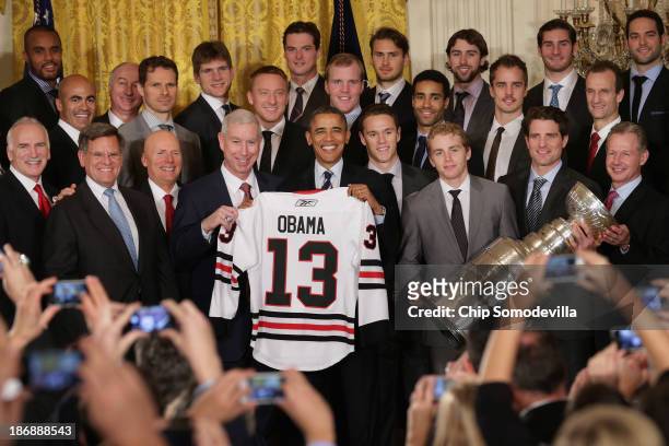 President Barack Obama poses for photographs with the National Hockey League 2013 champion Chicago Blackhawks Coach Joel Quenneville, principal owner...