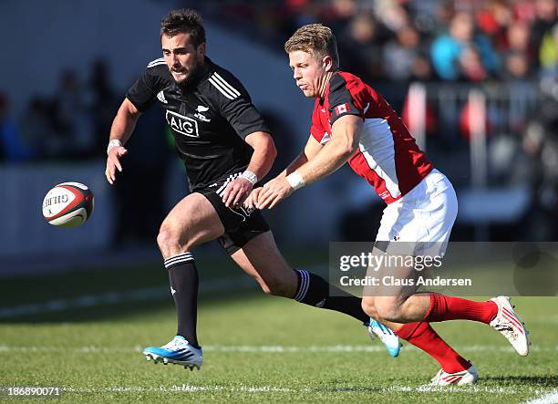 Andre Taylor of the New Zealand Maori All Blacks plays against John Moonlight of Team Canada during the AIG Canada exhibition game at BMO Field on...