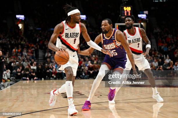 Jerami Grant of the Portland Trail Blazers dribbles against Kevin Durant of the Phoenix Suns during the second quarter of the game at the Moda Center...