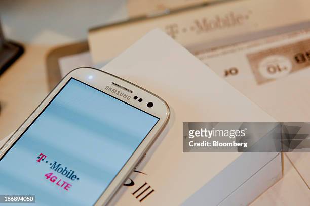 New Samsung Electronics Co. Galaxy 3 smartphone is set up for a customer at a T-Mobile US Inc. Retail store in Torrance, California, U.S., on Monday,...