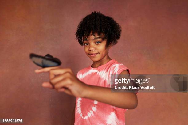 portrait of smiling girl with butterfly on finger - budding tween stock pictures, royalty-free photos & images