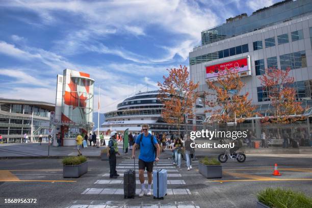 crowd of tourists at canada place on a sunny autumn day, vancouver, canada - vancouver canada place stock pictures, royalty-free photos & images