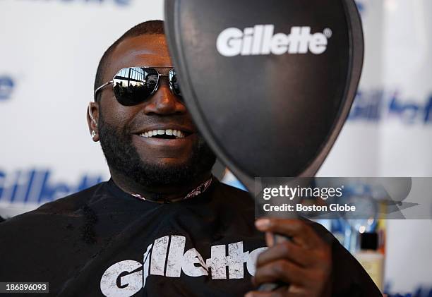 Boston Red Sox player David Ortiz takes one last look at his beard before shaving it off at Gillette World Shaving Headquarters in Boston on November...
