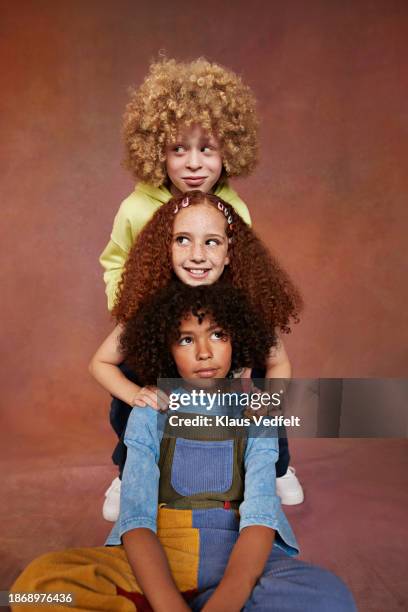 smiling multiracial friends leaning head on each other - budding tween stock pictures, royalty-free photos & images