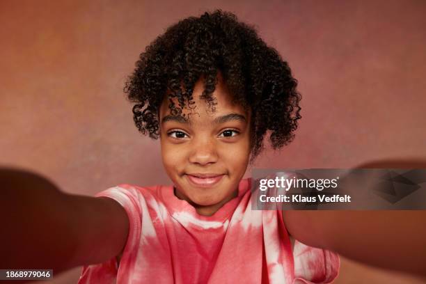 smiling girl with black curly hair taking selfie - curly girl stock pictures, royalty-free photos & images