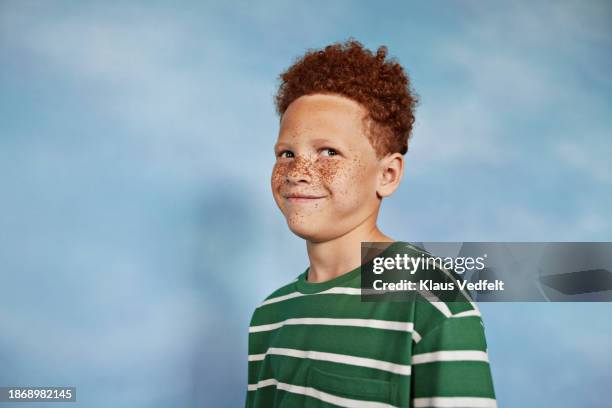 smiling boy with freckles looking sideways - striped tshirt stock pictures, royalty-free photos & images