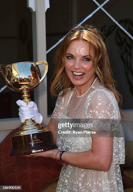 Geri Halliwell poses with the Melbourne Cup during Melbourne Cup Day at Flemington Racecourse on November 5, 2013 in Melbourne, Australia.