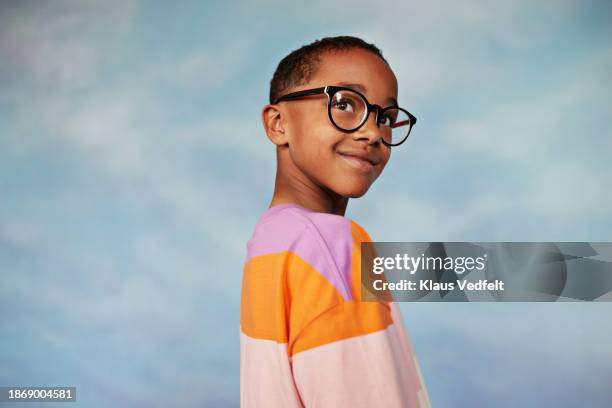 smiling boy wearing eyeglasses looking away - one boy only stock pictures, royalty-free photos & images