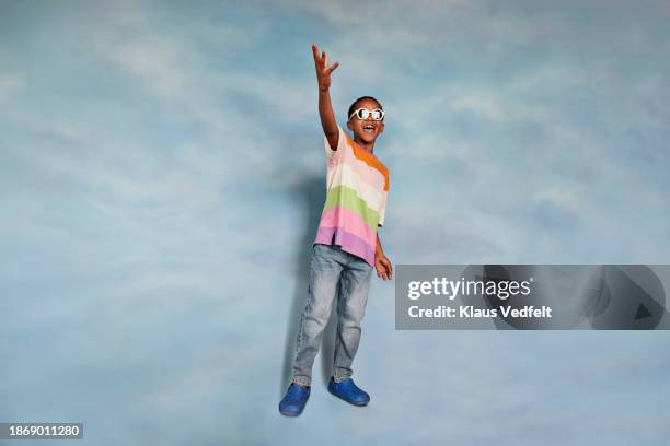 boy with mouth open gesturing - multi coloured trousers stock pictures, royalty-free photos & images