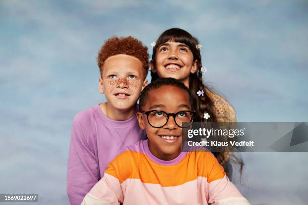 happy friends looking up together - budding tween stock pictures, royalty-free photos & images