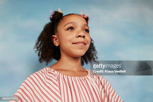 smiling girl wearing striped top looking away - budding tween stock pictures, royalty-free photos & images