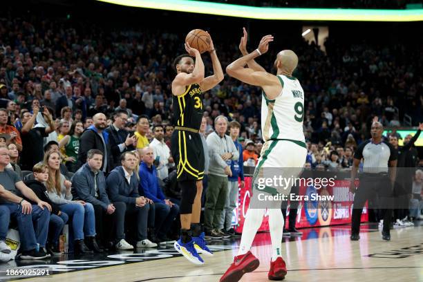 Stephen Curry of the Golden State Warriors makes a three-point basket over Derrick White of the Boston Celtics at the end of overtime to clinch their...