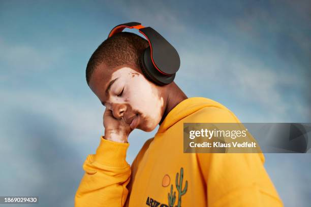 boy listening to music with eyes closed - african kids stylish stock pictures, royalty-free photos & images
