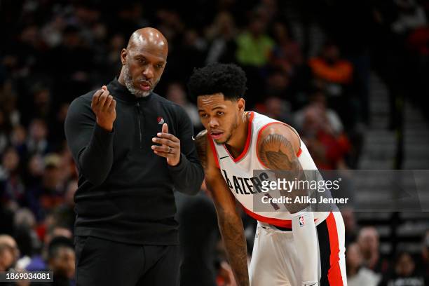 Head coach Chauncey Billups of the Portland Trail Blazers and Anfernee Simons talk during the third quarter of the game against the Phoenix Suns at...