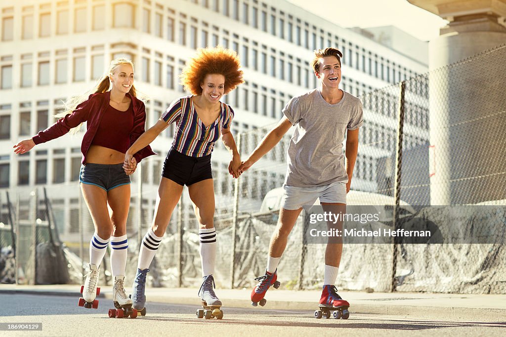 Three young people rollerskating