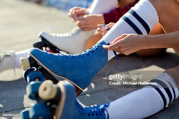 close up of rollerskates being laced up - rolschaatsen schaats stockfoto's en -beelden