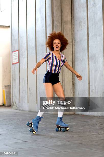 young woman rollerskating - rollerskates foto e immagini stock