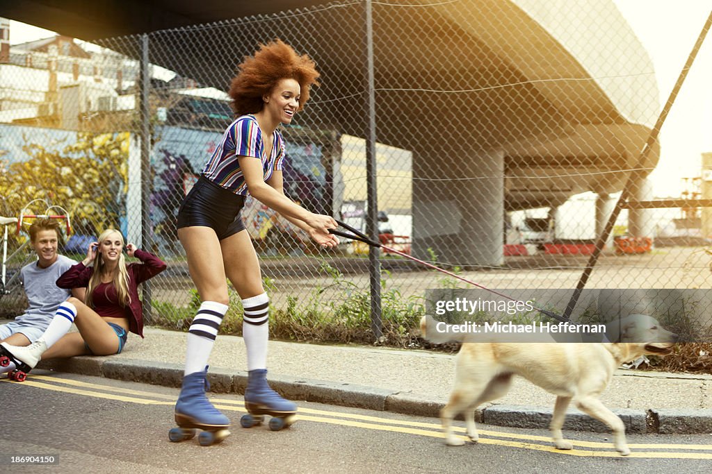 Young woman roller skating with dog