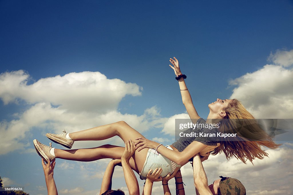 Female teenager held up triumphantly