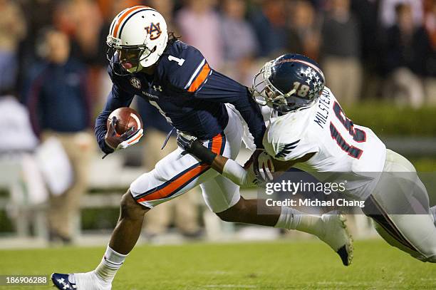 Defensive back Christian Milstead of the Florida Atlantic Owls attempts to tackle wide receiver Trovon Reed of the Auburn Tigers on October 26, 2013...