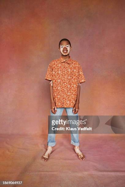 smiling boy with vitiligo standing in casuals - floral pattern trousers stock pictures, royalty-free photos & images