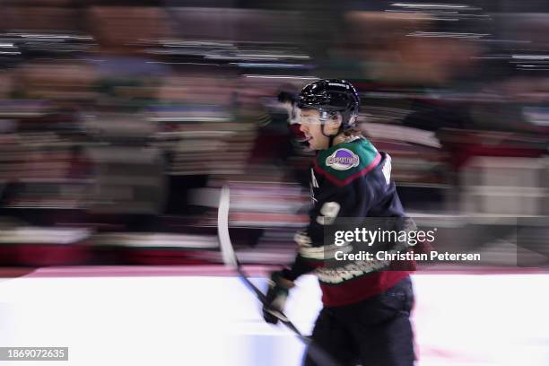 Clayton Keller of the Arizona Coyotes celebrates with teammates on the bench after scoring a goal against the Ottawa Senators during the third period...