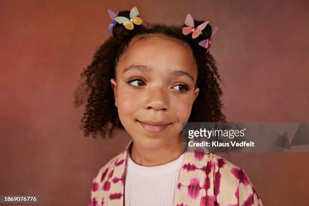 smiling girl with butterfly clips - budding tween stock pictures, royalty-free photos & images