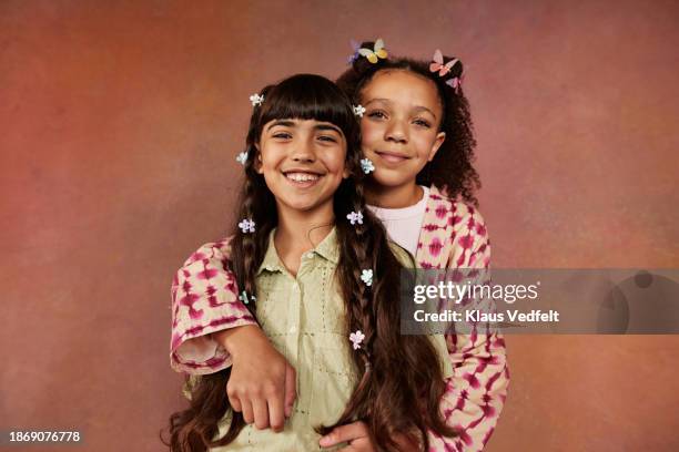 smiling girl hugging friend from behind - iranian people stock pictures, royalty-free photos & images