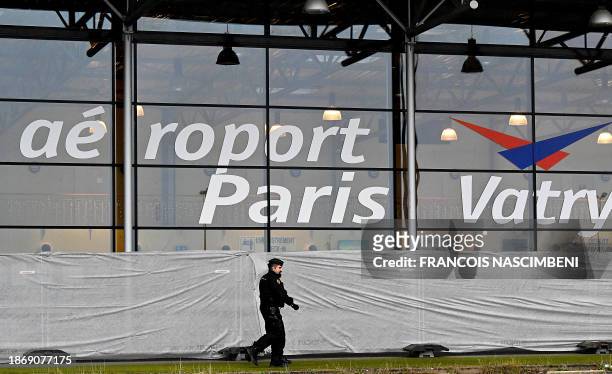 French gendarme patrols around a terminal at Vatry airport, north-eastern France, on December 23, 2023 two days after officials grounded a...