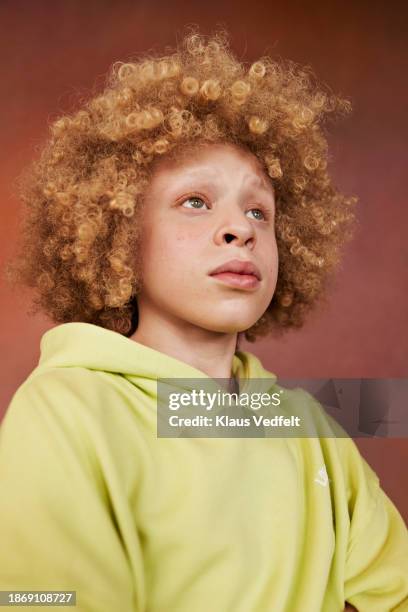 thoughtful albino boy with curly blond hairstyle - afro stock pictures, royalty-free photos & images