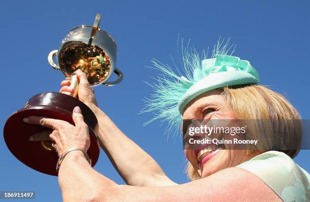 Gai Waterhouse the trainer of Fiorente holds up the Melbourne Cup after winning race 7 the Emirates Melbourne Cup during Melbourne Cup Day at...